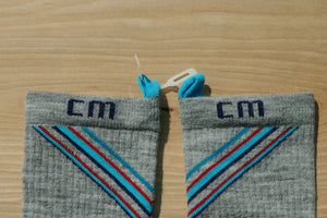 Step 2: E-Zmate clip being threaded through the blue linking loops on Climatesox.com Men's Merino Wool Light-Hiking Crew Socks