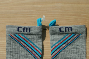 Step 1: Climatesox.com E-Zmate Men's Merino Wool Crew Socks side by side showing the blue linking loops at the cuff before connecting with link left on one sock while wearing. 