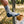 Man wearing Climatesox E-Zmate Men's Linkable Merino Wool Hiking Crew Socks with foot resting on a rustic fence rail in a sunny meadow.